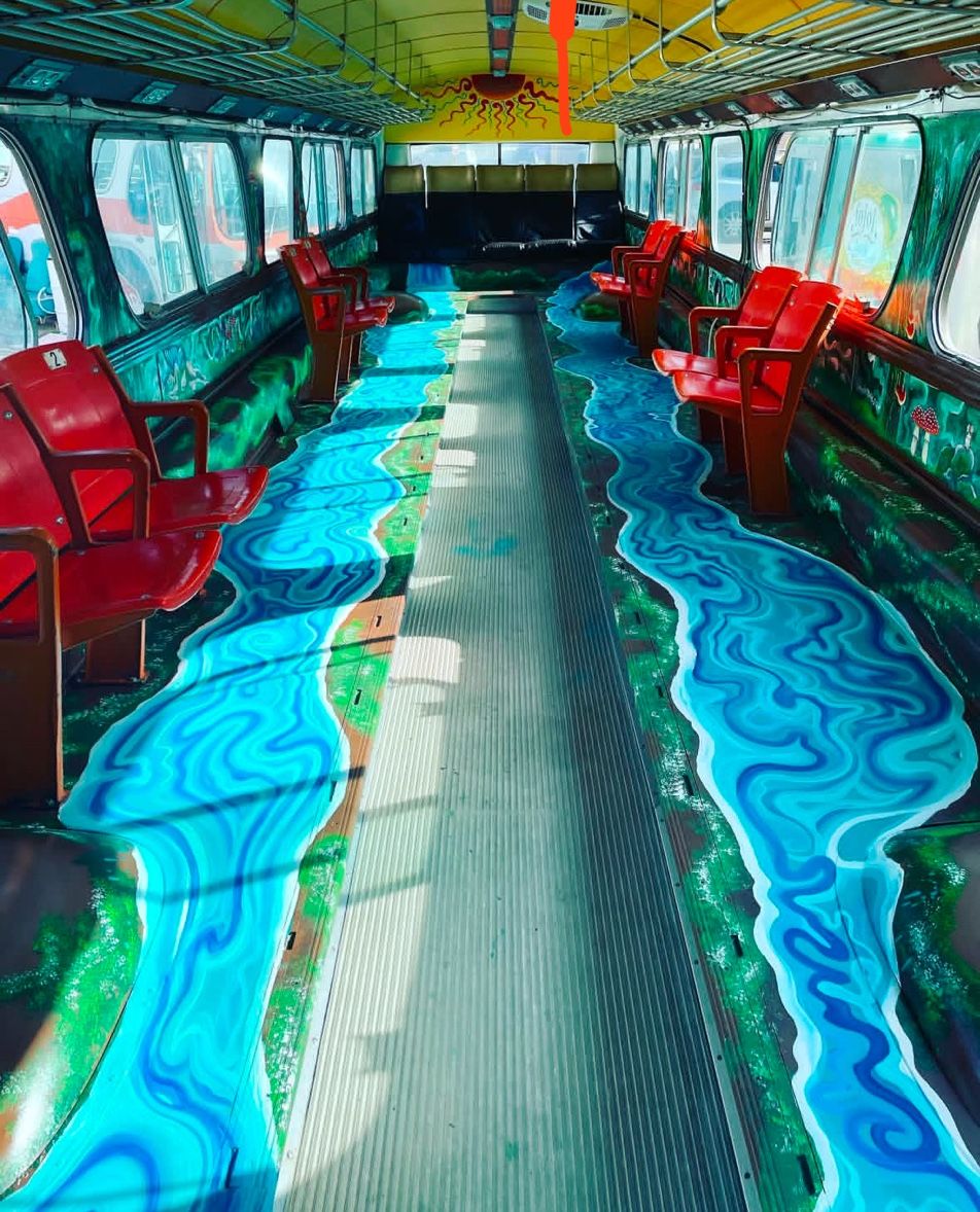 Inside the music meditation bus, hand-painted flowing water murals